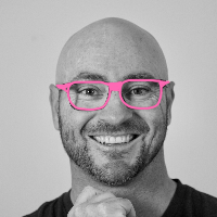 Dave with a goofy smile and pretty pink glasses